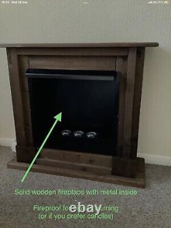 Biofuel canisters in solid wooden fireplace with Extinguisher & Fuel Saving Rings